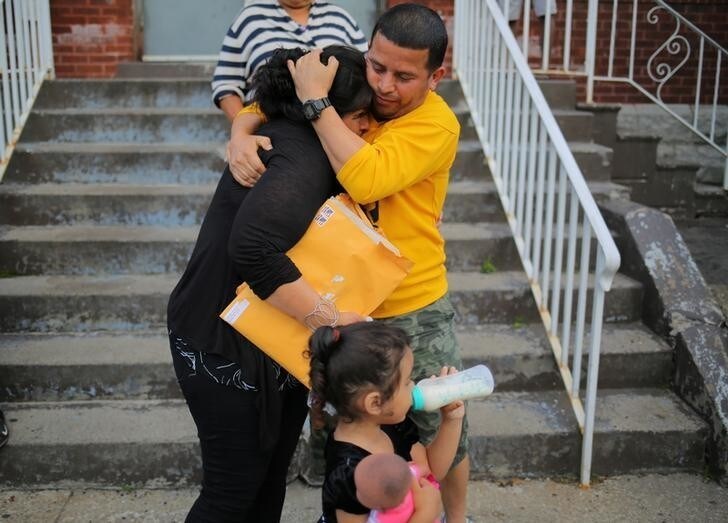 A woman from El Salvador (L), requesting to be identified only as "E" for her family's safety, is embraced by a family friend before leaving Vive La Casa shelter by taxi with her daughters to file a refugee claim at the Canadian border, in Buffalo, New York, U.S. July 5, 2017. Picture taken July 5, 2017. REUTERS/Chris Helgren
