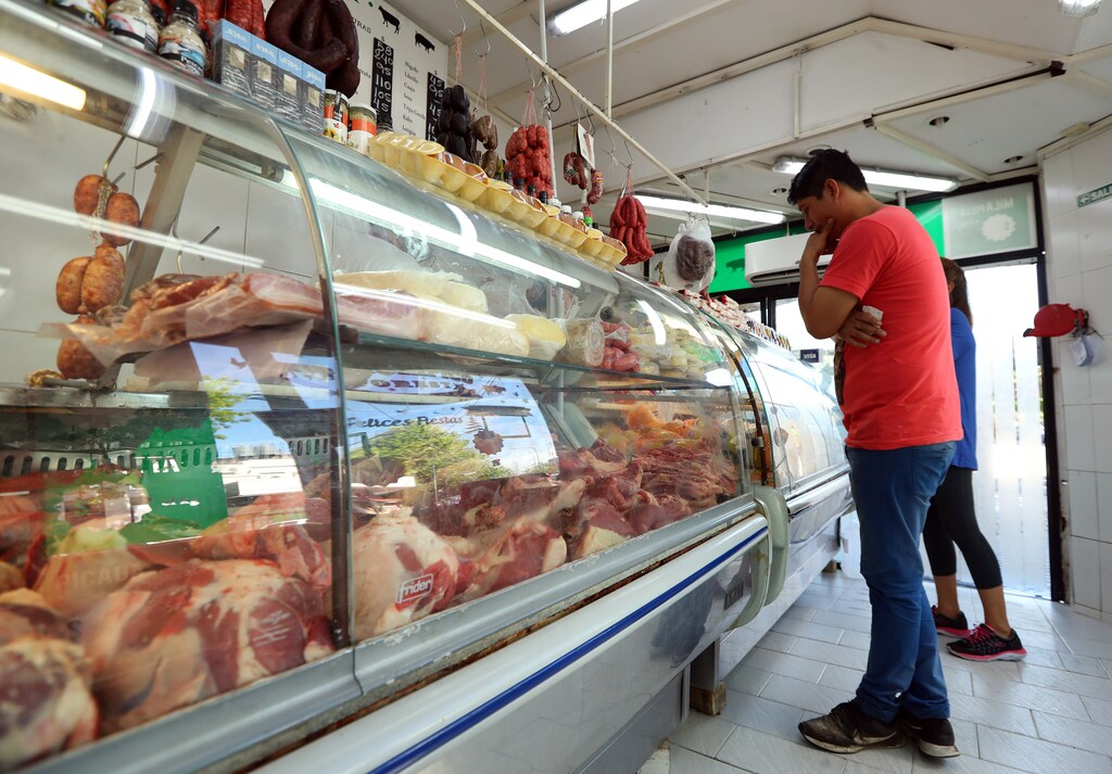 A man looks at meat on display inside a butcher shop in Buenos Aires, Argentina October 29, 2018. Picture taken October 29, 2018. REUTERS/Marcos Brindicci - RC1A92DD1360