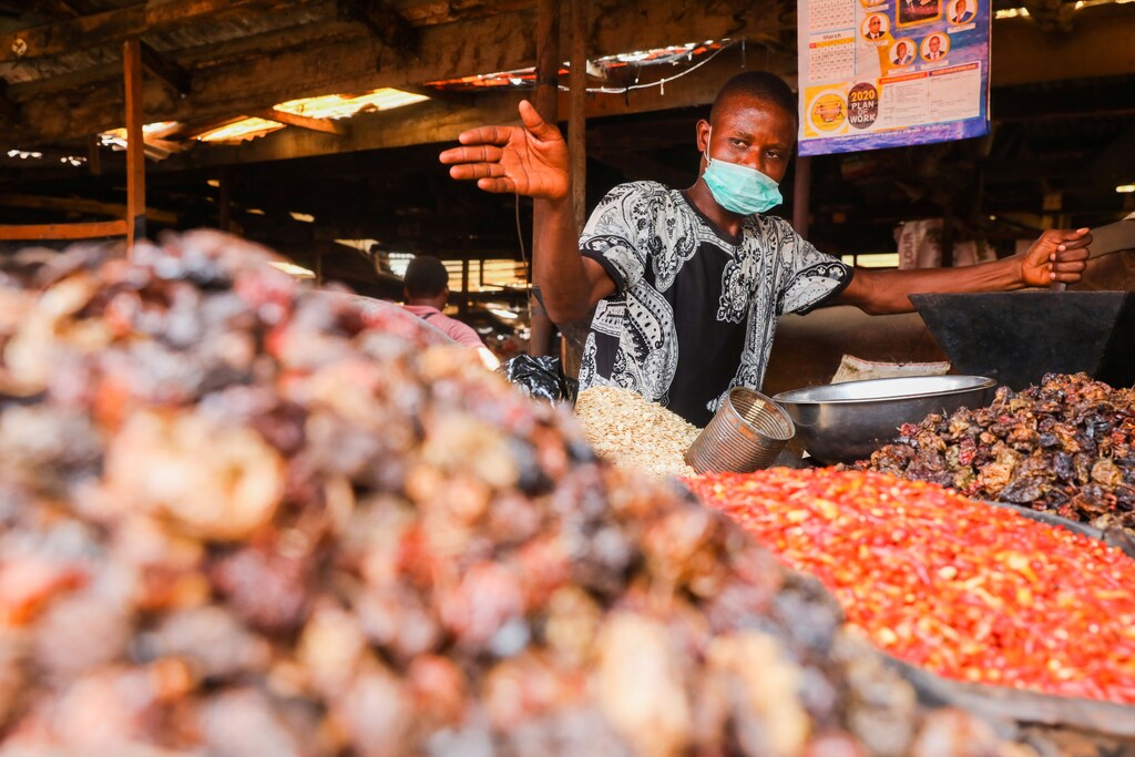 A trader gestures in his stall at a food market after Nigeria's President Muhammadu Buhari called for a lockdown starting tonight to limit the spread of coronavirus disease (COVID-19), in Lagos, Nigeria March 30, 2020.