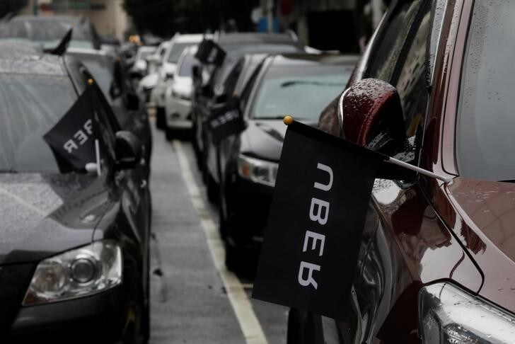 Uber drivers' cars are seen parked during a protest outside the Ministry of Transportation building in Taipei, Taiwan February 26, 2017. REUTERS/Tyrone Siu