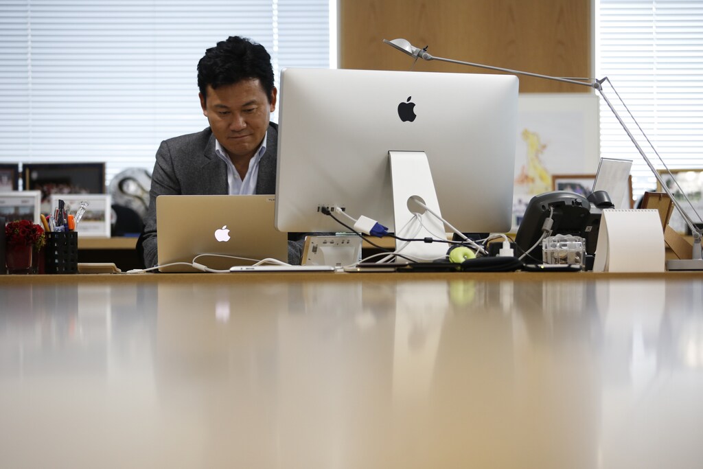 a businessman sits at his desk behind a computer