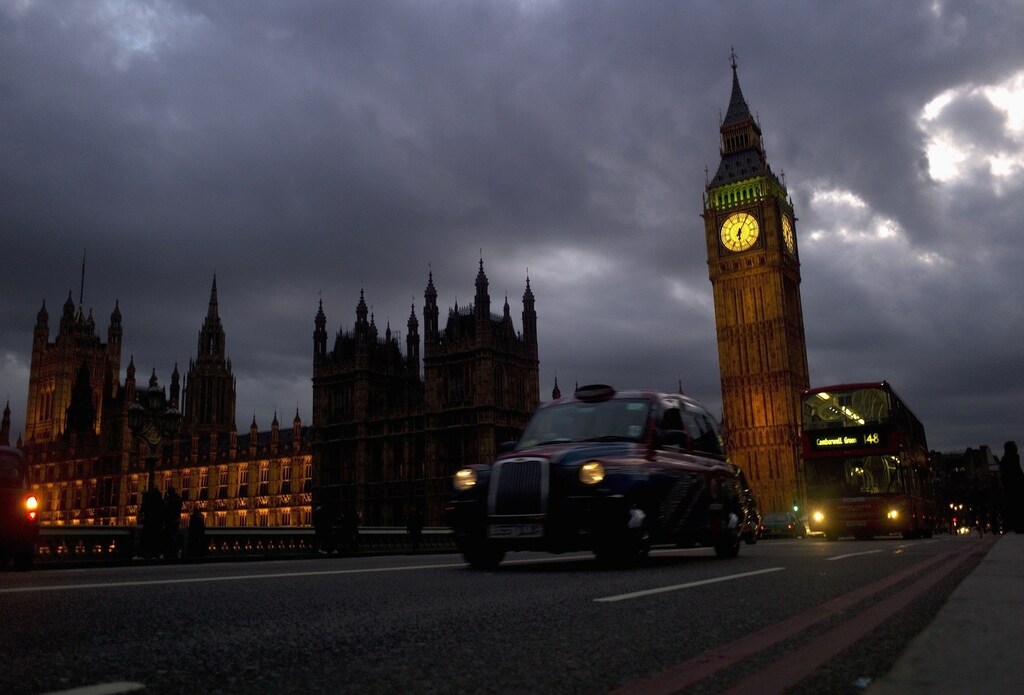 A bus and taxi pass Big Ben on Westminster Bridge in London March 10, 2012. London will host the Olympics Games this summer. Picture taken March 10, 2012