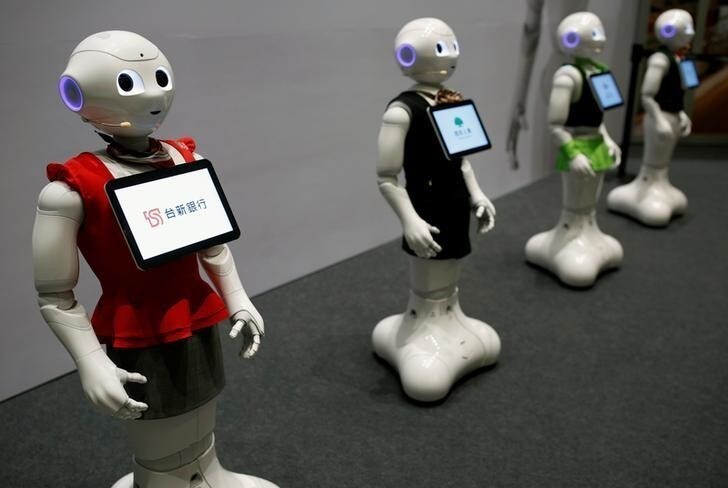 SoftBank's robots 'pepper', dressed in different bank uniforms, are displayed during a news conference in Taipei, Taiwan July 25, 2016