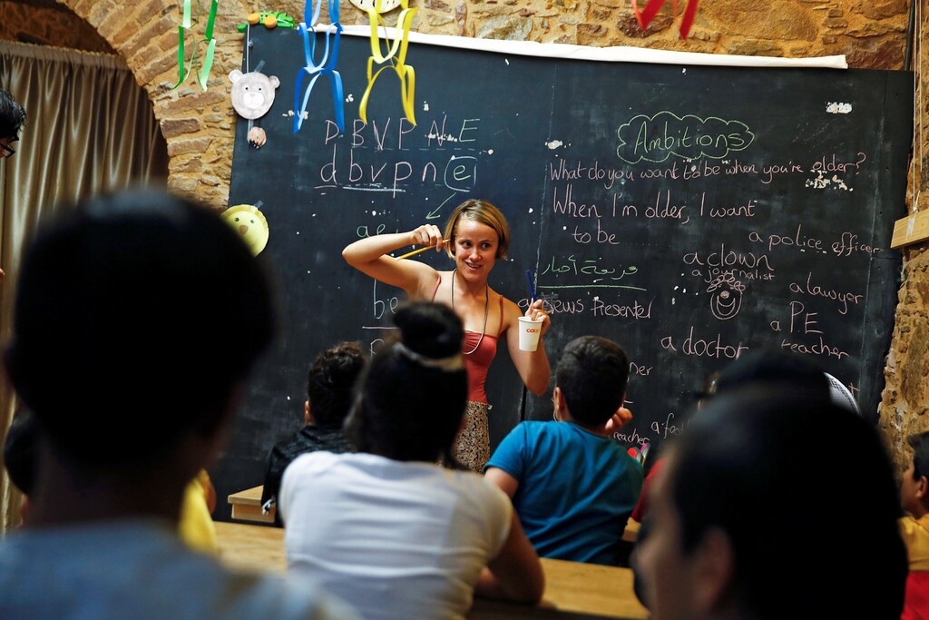 British volunteer primary school teacher Helen Brannigan holds a pen and a cup as she conducts an English class to refugee children at the volunteer-run "Refugee Education Chios" school on the island of Chios, Greece September 6, 2016.