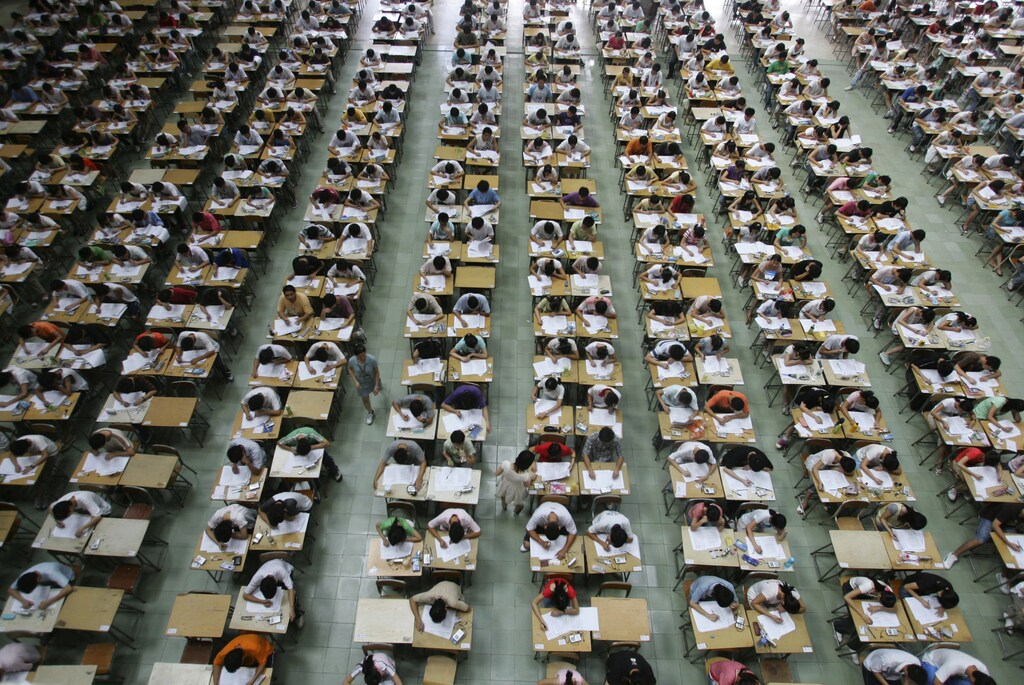 Students take their examination in an exam hall in Dongguan University of Technology, in south China's Guangdong province, July 9, 2007. Around 1,200 students took their English examination in a large hall so as to prevent exam fraud. Picture taken July 9, 2007. REUTERS/China Daily (CHINA) CHINA OUT - RTR1RPJP