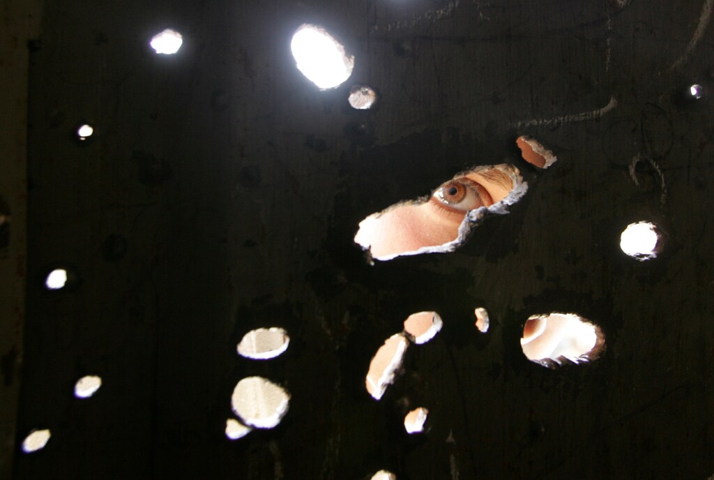 A Palestinian boy looks at a shop destroyed by an Israeli tank shell in Gaza June 27, 2007.