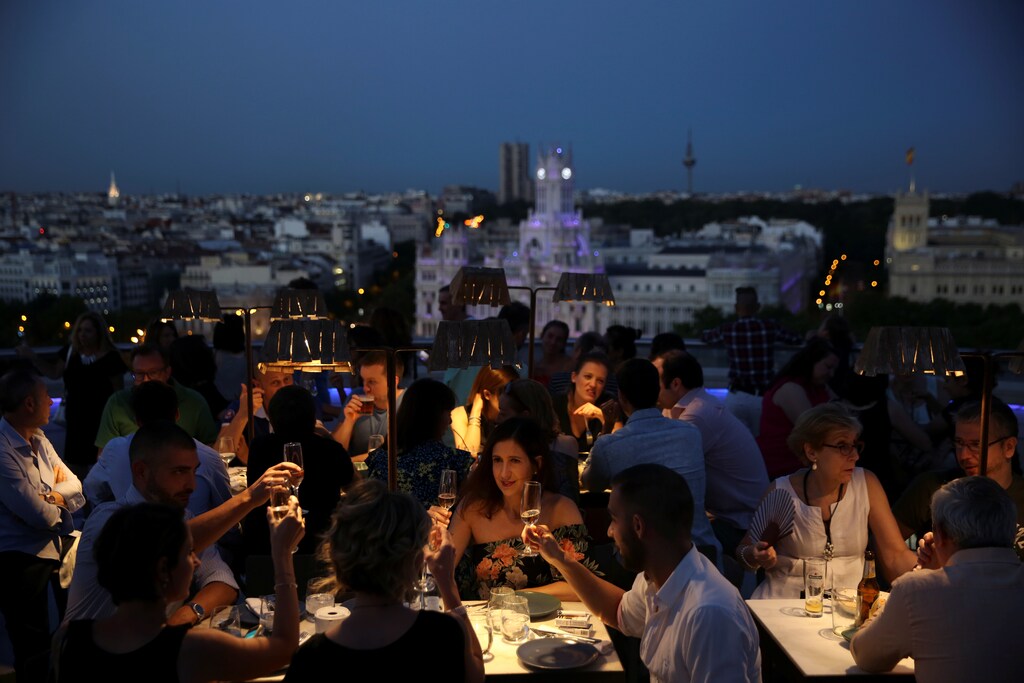 People make a toast at the Circulo de Bellas Artes rooftop terrace in Madrid, June 23, 2017. REUTERS/Susana Vera - RTS18EWR
