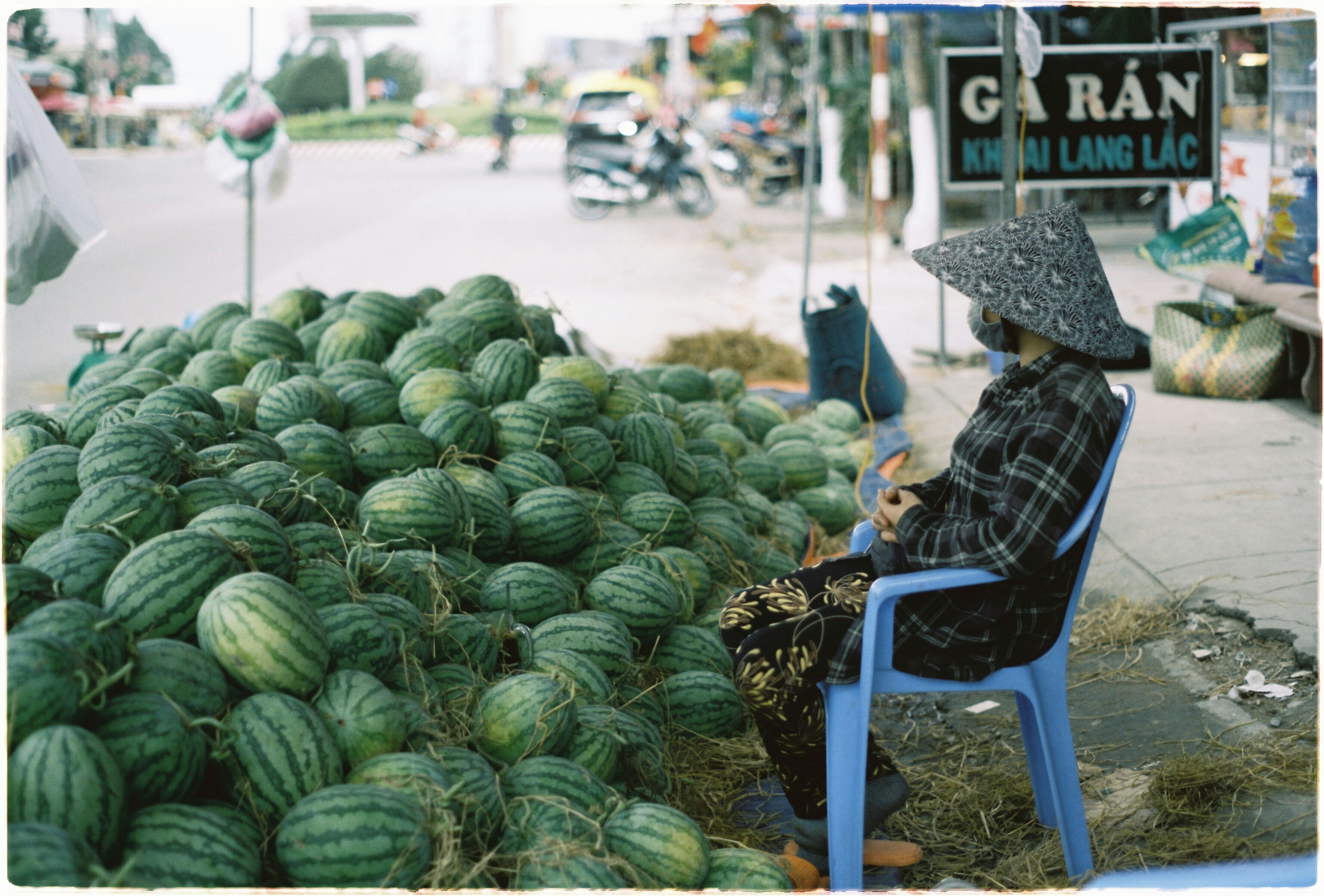 Street vendor selling watermelons.