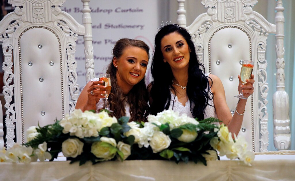 Sharni Edwards, 27, and Robyn Peoples, 26, a Belfast couple who are the first known same-sex couple to get married in Northern Ireland, pose after being married, in Carrickfergus, Northern Ireland February 11, 2020. REUTERS/Phil Noble - RC2EYE9DL2VG