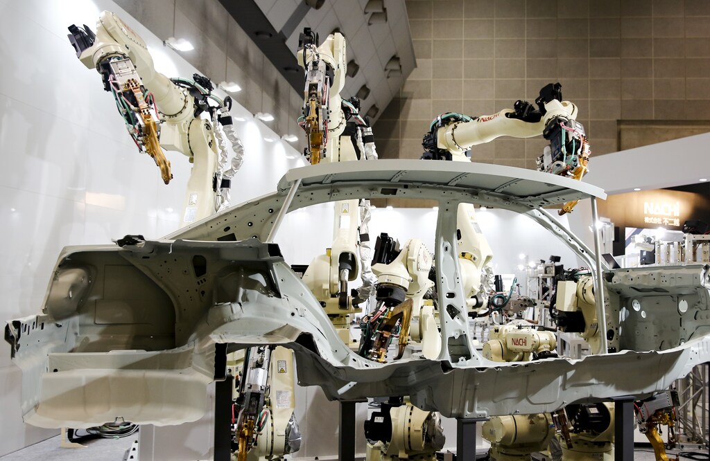 Robot arms by Nachi Robotic Systems work on the body of a car at the International Robot Exhibition in Tokyo, Japan December 2, 2015.