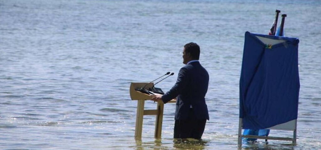 Tuvalu's Minister for Justice, Communication & Foreign Affairs Simon Kofe delivers a statement to COP26 while standing in the ocean in Funafuti, Tuvalu November 5, 2021
