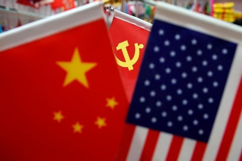 The flags of China, U.S. and the Chinese Communist Party are displayed in a flag stall at the Yiwu Wholesale Market in Yiwu, Zhejiang province, China, May 10, 2019. REUTERS/Aly Song - RC16D2FCA740