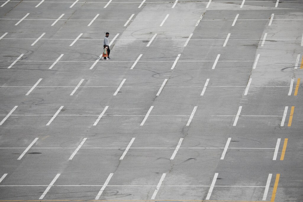 A father and his daughter wear masks to avoid contracting the coronavirus disease (COVID-19) as they walk on an empty parking lot of a park in Paju, South Korea, September 28, 2021. REUTERS/Kim Hong-Ji - RC2RYP92GJ2A