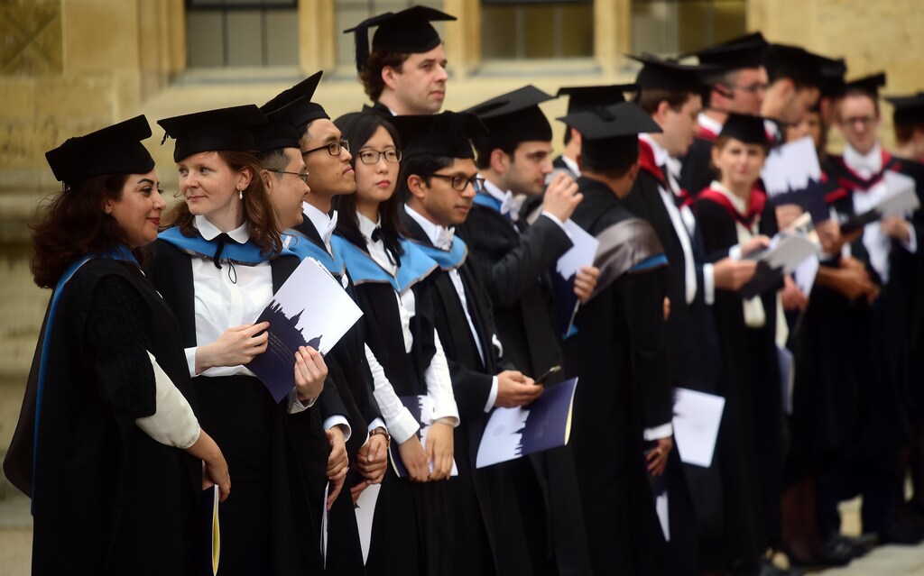 Graduates gather outside the Sheldonian Theatre after a graduation ceremony at Oxford University, in Oxford, Britain July 15, 2017. REUTERS/Hannah McKay - RTX3BLAC