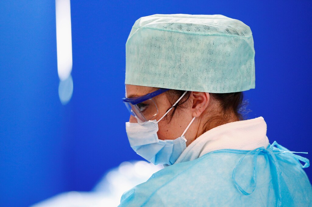 A nurse in a protective suit is pictured at a drive-in testing site for coronavirus (COVID-19) at the Regional Hospital Center in Liege, Belgium March 11, 2020. REUTERS/Francois Lenoir - RC2QHF98SI02