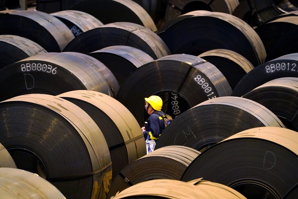A worker walks past steel rolls at the ArcelorMittal steel plant in Sestao, Spain, November 12, 2018. REUTERS/Vincent West - RC1C72F35FF0