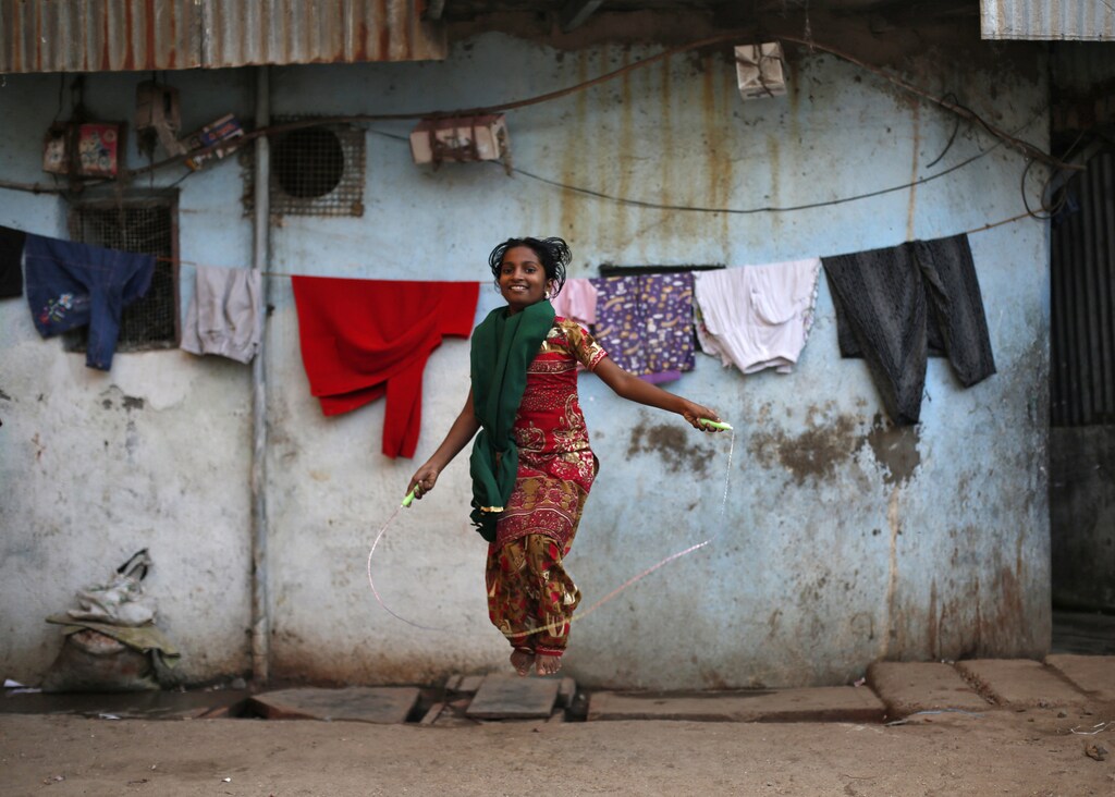 A girl jumps rope outside her house in Dharavi, one of Asia's largest slums, in Mumbai January 24, 2014.