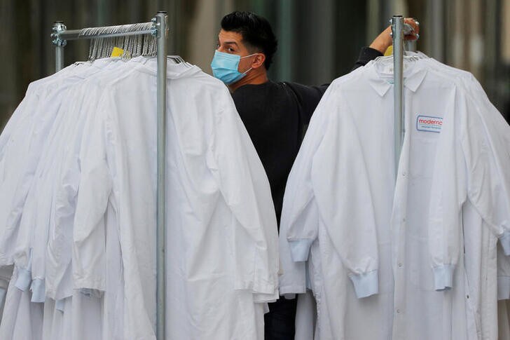 A worker delivers protective lab coats to the headquarters of Moderna Therapeutics, which is developing a vaccine against the coronavirus disease (COVID-19), in Cambridge, Massachusetts, U.S., May 18, 2020. REUTERS/Brian Snyder TPX IMAGES OF THE DAY