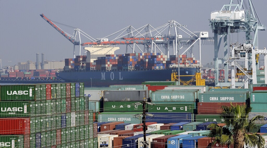 Cargo containers sit idle at the Port of Los Angeles as a back-log of over 30 container ships sit anchored outside the Port in Los Angeles, California, February 18, 2015.