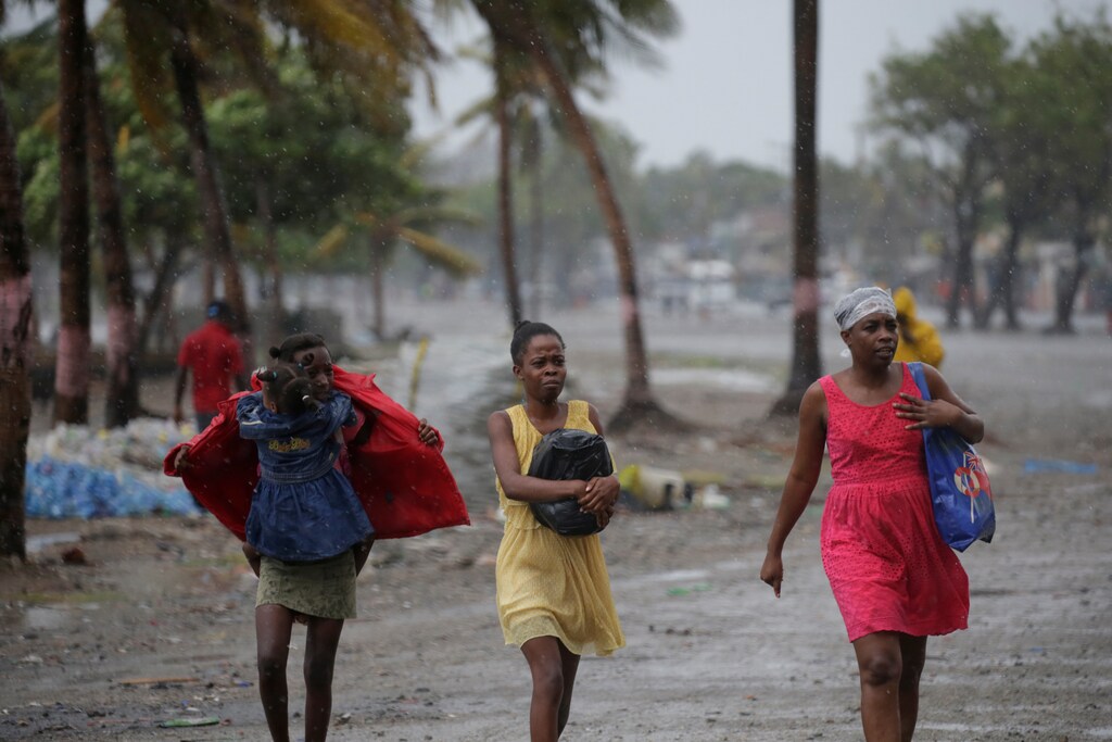 Women walk in the rain brought by Hurricane Irma in Cap-Haitien, Haiti, September 7, 2017. REUTERS/Andres Martinez Casares - RC19839A9800