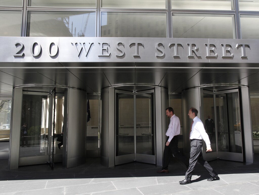 People walk past revolving doors of the new Goldman Sachs Group global headquarters