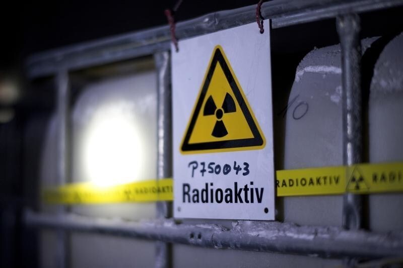 A radiation sign is attached to a barrel containing radioactive water during the visit of German Environment Minister Barbara Hendricks (not pictured) to the Asse nuclear waste disposal centre in a unused mine near the German village of Remlingen March 4, 2014. REUTERS/Jochen Luebke/Pool (GERMANY - Tags: POLITICS SCIENCE TECHNOLOGY) - LR1EA341517PH