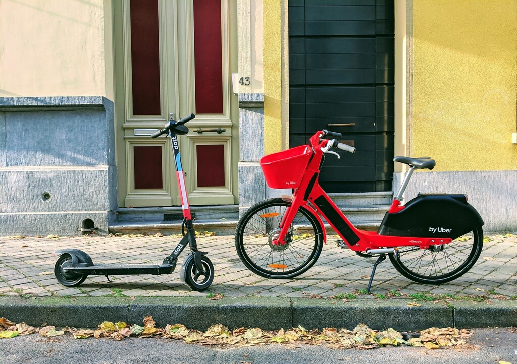 An e-scooter and e-bike on a street in Belgium, two examples of micromobility