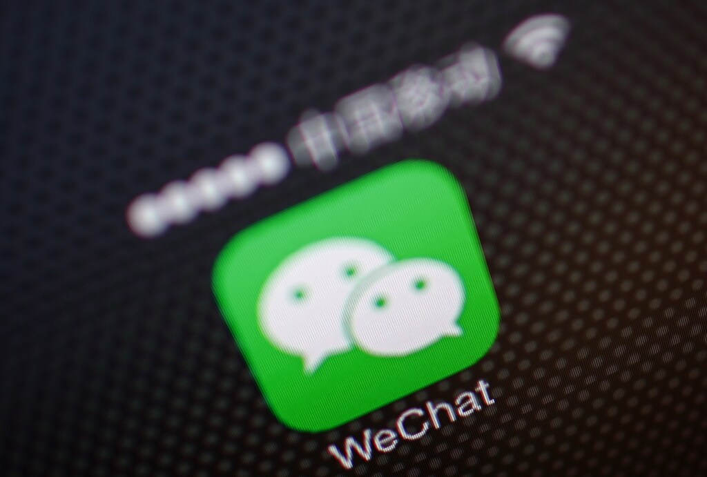 A picture illustration shows a WeChat app icon in Beijing, December 5, 2013. An unprecedented Nov. 14 leak of China's Communist Party reform plans fuelled China's biggest stock market rally in two months as it spread on microblogs and passed from smartphone to smartphone on WeChat, a three-year-old social messaging app developed by Tencent Holdings Ltd. WeChat, or Weixin in Chinese, meaning "micromessage", leapt from 121 million global monthly active users at the end of September 2012 to 272 million in just a year. It has quickly become the news source of choice for savvy mobile users in China, where a small army of censors scrub the country's Internet of politically sensitive news and "harmful" speech. Picture taken December 5, 2013. REUTERS/Petar Kujundzic (CHINA - Tags: BUSINESS POLITICS TELECOMS) - RTX16EHJ