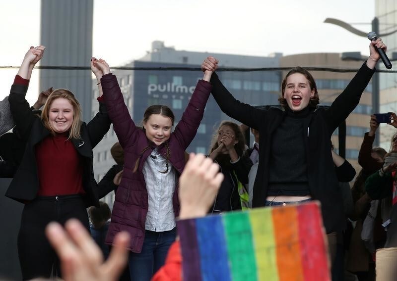 16-year-old Swedish environmental activist Greta Thunberg (C) and Anuna De Wever, (R), a Belgian climate student activist, are seen on stage as they take part in a protest claiming for urgent measures to combat climate, in central Brussels, Belgium February 21, 2019. REUTERS/Yves Herman - RC11BC1EF0C0