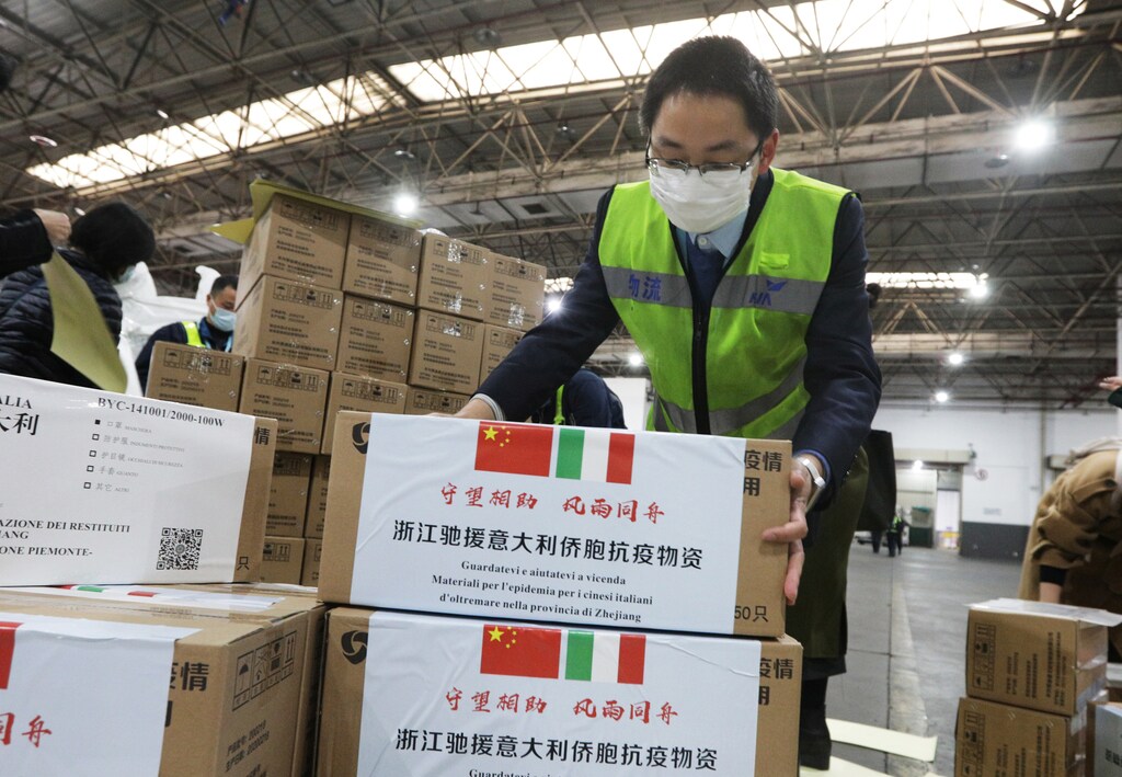 Staff members move medical supplies to be sent to Italy for the prevention of the novel coronavirus, following the coronavirus outbreak, at a logistics center of the international airport in Hangzhou, Zhejiang province, China March 10, 2020. Picture taken March 10, 2020. China Daily via REUTERS ATTENTION EDITORS - THIS IMAGE WAS PROVIDED BY A THIRD PARTY. CHINA OUT. - RC27IF9T61PM