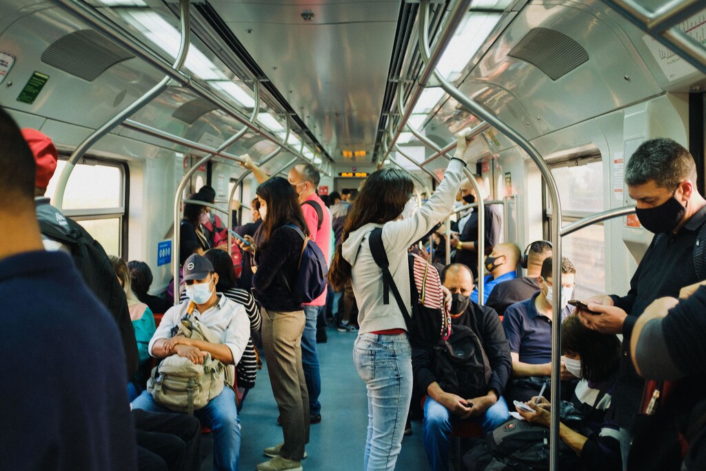 People standing and sitting on a train