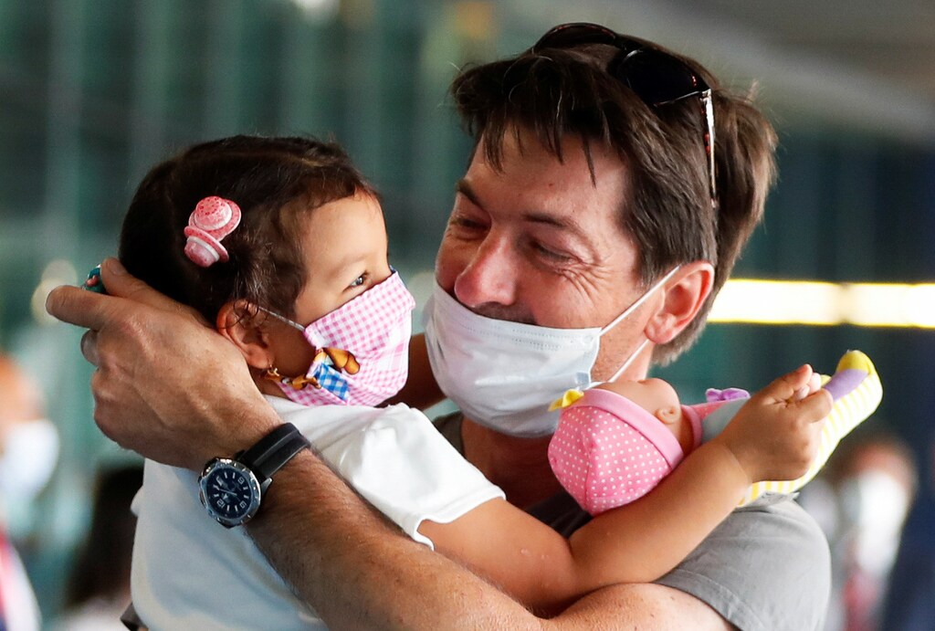 Sandro Manzato from Italy hugs his daughter Yarline, after she came back with his wife Rubiela Perea from Colombia where they were since the 2nd of February, as Italy eases movement between regions, while the country unwinds its rigid lockdown due to the coronavirus disease (COVID-19) outbreak, at Fiumicino Airport, in Rome, Italy June 3, 2020. REUTERS/Yara Nardi - RC2N1H9TP3HF