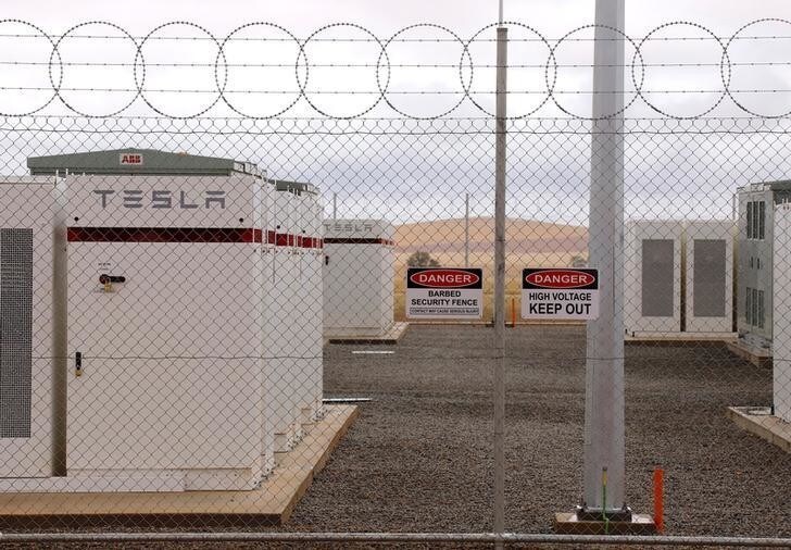 Warning signs adorn the fence surrounding the compound housing the Hornsdale Power Reserve, featuring the world's largest lithium ion battery made by Tesla, during the official launch near the South Australian town of Jamestown, in Australia, December 1, 2017. REUTERS/David Gray