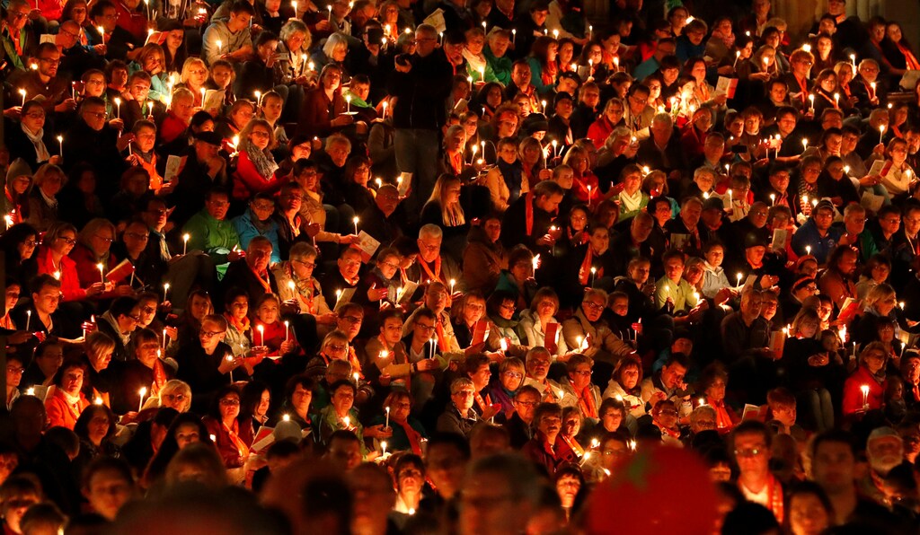 People pray during an evening prayer of the German protestant church congress Kirchentag at Gendarmenmarkt square in Berlin, Germany, May 24, 2017. REUTERS/Fabrizio Bensch - RC17AA12D4D0