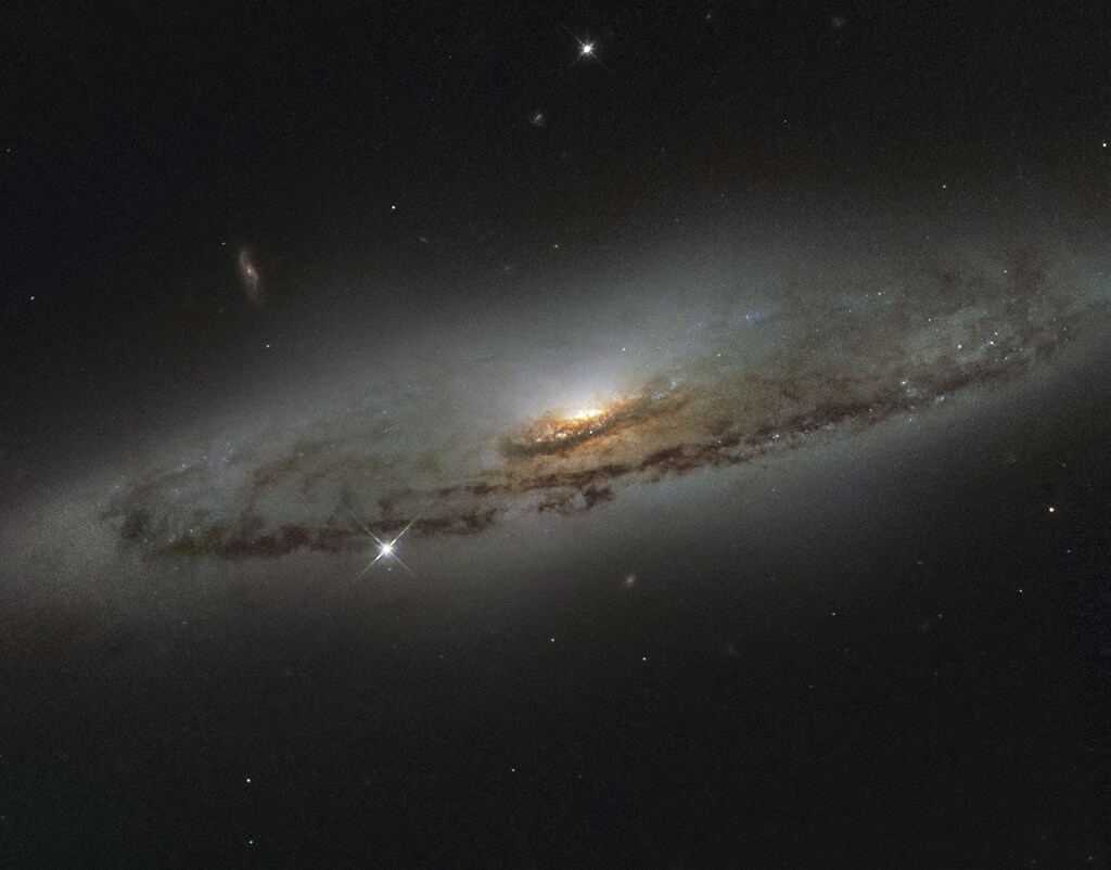 The spiral galaxy NGC 4845, located over 65 million light-years away in the constellation of Virgo (The Virgin) is shown in this NASA/ESA Hubble Space Telescope image released on January 8, 2016. The galaxy?s orientation clearly reveals the galaxy?s striking spiral structure: a flat and dust-mottled disc surrounding a bright galactic bulge. NGC 4845?s glowing center hosts a gigantic version of a black hole, known as a supermassive black hole. REUTERS/NASA/Handout FOR EDITORIAL USE ONLY. NOT FOR SALE FOR MARKETING OR ADVERTISING CAMPAIGNS. THIS IMAGE HAS BEEN SUPPLIED BY A THIRD PARTY. IT IS DISTRIBUTED, EXACTLY AS RECEIVED BY REUTERS, AS A SERVICE TO CLIENTS - RTX21KFS