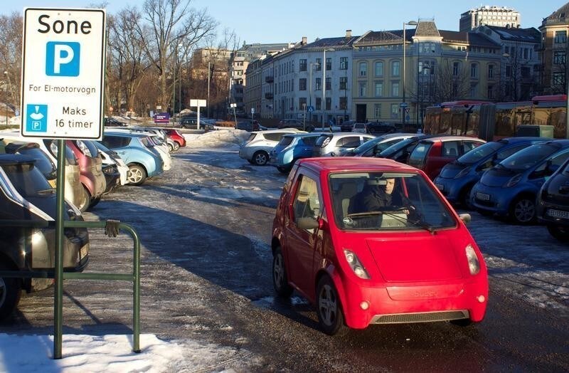 A driver leaves a free car park reserved for electric vehicles in Oslo, Norway, February 25, 2013.