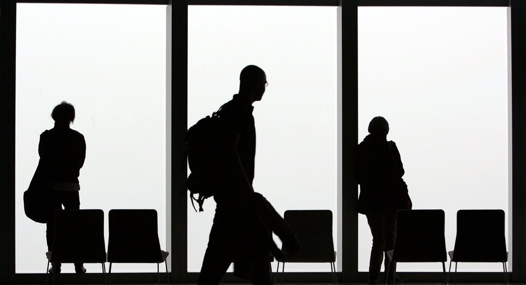 Visitors is silhouetted against a cloudy sky on the observation deck of a skyscraper in Tokyo February 23, 2007. REUTERS/Kim Kyung-Hoon (JAPAN)Also see GF2DWTFXPQAA - RTR1MQ3F