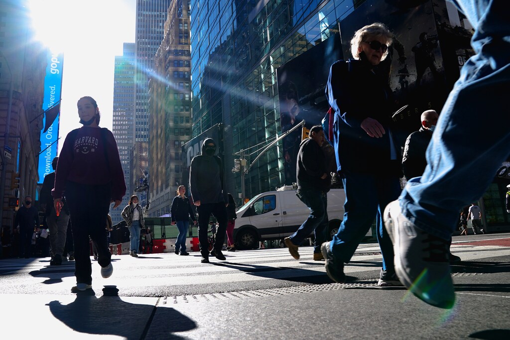 People walk though Times Square during the coronavirus disease (COVID-19) pandemic in the Manhattan borough of New York City, New York, U.S., November 10, 2021. REUTERS/Carlo Allegri