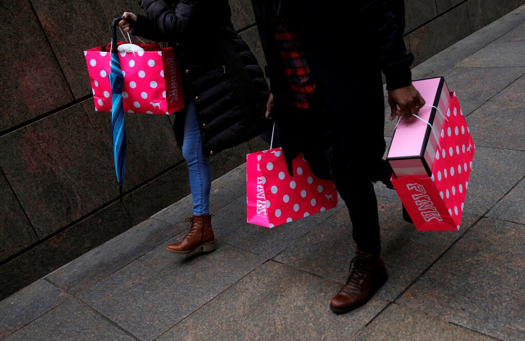 People walk with shopping bags in Manhattan, New York City, U.S. December 27, 2016.