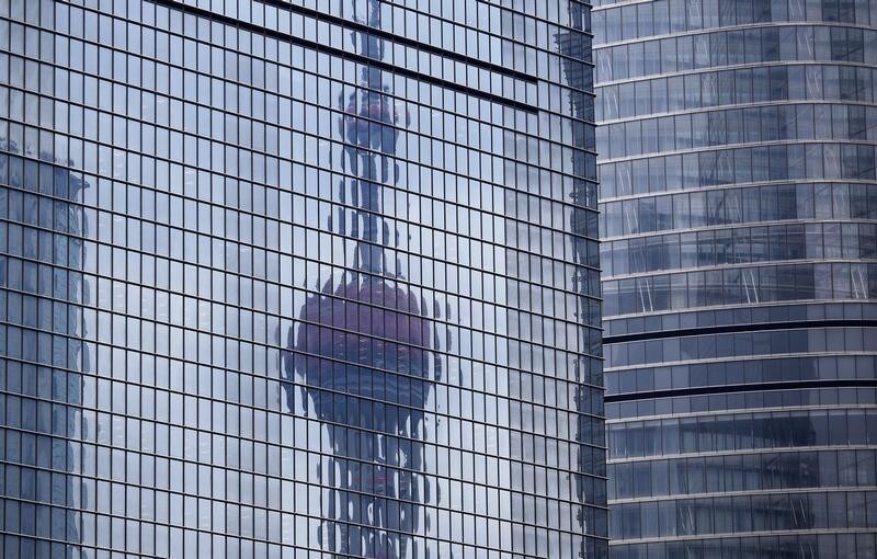 The Oriental Pearl TV Tower reflected on the facade of another building at Pudong financial district in Shanghai April 2, 2014. China's Vice Premier Zhang Gaoli called for faster construction of certain important projects on Tuesday, in remarks that may feed speculation that China will increase state spending in coming months to bolster its stuttering economy. China's economy has had a surprisingly soft start to the year, rattling investors who had expected a stable performance and who now fear China may drag on global growth. Two surveys on Tuesday showed China's manufacturing sector remained weak in March. REUTERS/Carlos Barria (CHINA - Tags: BUSINESS CITYSCAPE MEDIA TPX IMAGES OF THE DAY) - GM1EA421F8L01