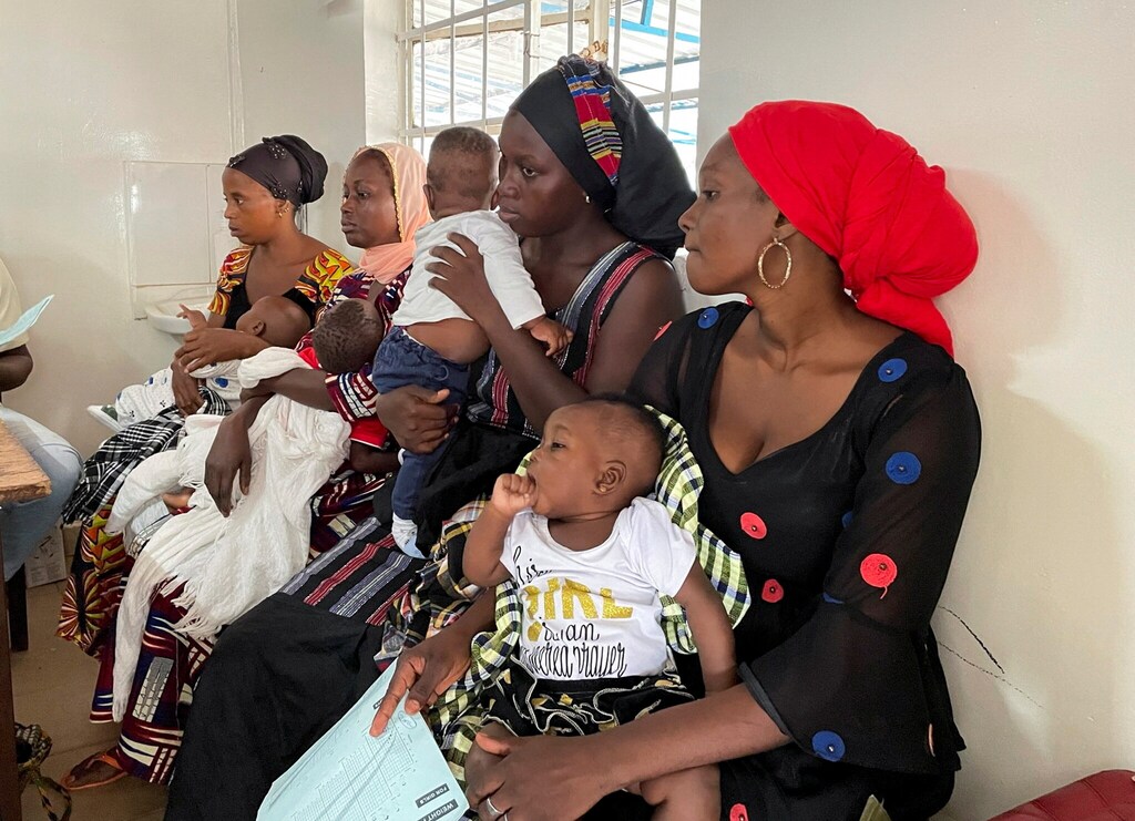 Mothers wait with their children for measles vaccinations in Bundung, Gambia.