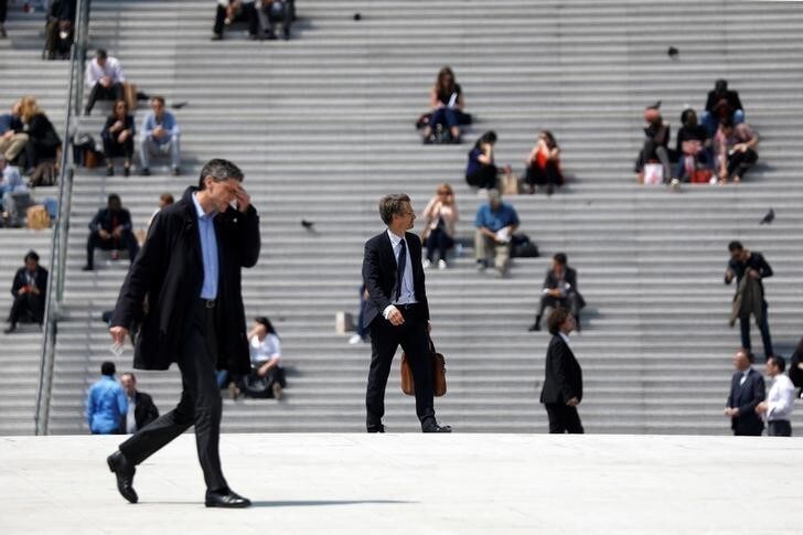 Businessmen walk on the esplanade of La Defense financial and business district in Puteaux, near Paris, France, May 16, 2018. REUTERS/Charles Platiau
