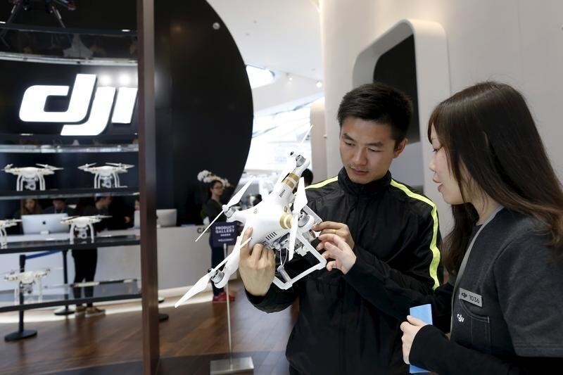 A customer holds a DJI's Phantom 3 Standard drone at their first flagship store in Shenzhen, Guangdong province, China December 20, 2015, two days before the official opening. Chinese drone developers are racking up an impressive list of aerial solutions for a growing variety of demands, from police surveillance to agricultural mapping and traffic management. Already well established as a world leader in drone manufacturing, China is slowly emerging as a world-class innovator, not just a duplicator of foreign designs. REUTERS/Tyrone Siu - GF10000272157