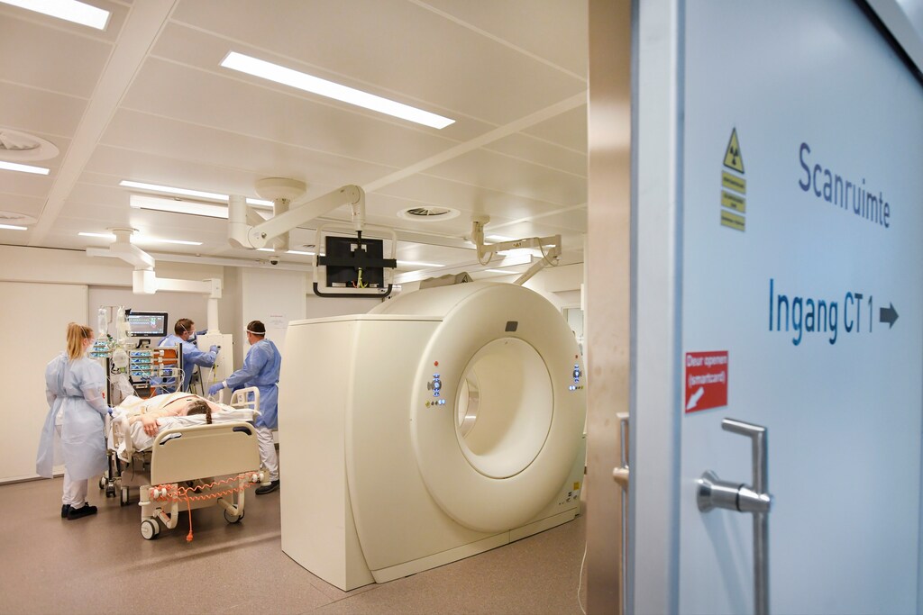 Members of the medical personnel wearing full protective suits prepare a patient infected with the coronavirus disease (COVID-19) for a CT scan at Maastricht UMC+ Hospital in Maastricht, Netherlands, November 10, 2020.