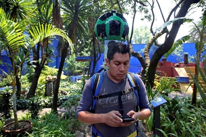 A Google employee, armed with a specialized Street view 360 degree camera, documents the garden at the childhood home of Mexican artist Frida Kahlo, now Frida Kahlo Museum, also known as "Casa Azul", in Mexico City, Mexico May 21, 2018.