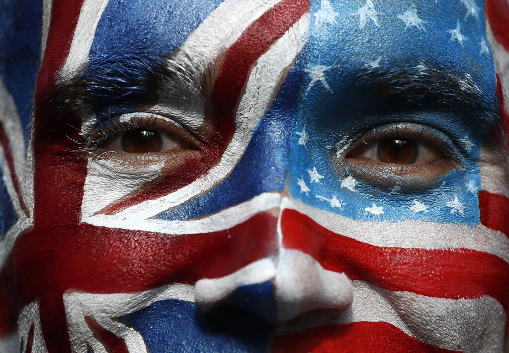 A campaigner with a face-painting poses outside a 'Stop Trump' open-top double decker bus before touring London to urge Americans living abroad to register and vote, Britain September 21, 2016. REUTERS/Stefan Wermuth TPX IMAGES OF THE DAY - RTSORAC