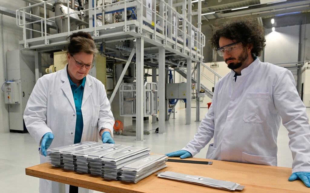 Technicians control battery cells, as Blackstone company starts production at gigafactory for 3d printed batteries in Doebeln, Germany.