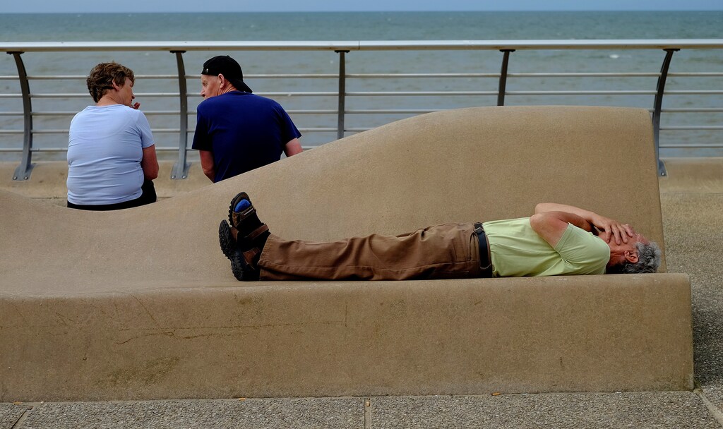 A man sleeps in the sun on the promenade in Blackpool, northern England, Britain July 21, 2016. REUTERS/Phil Noble - D1BETQVUQPAB