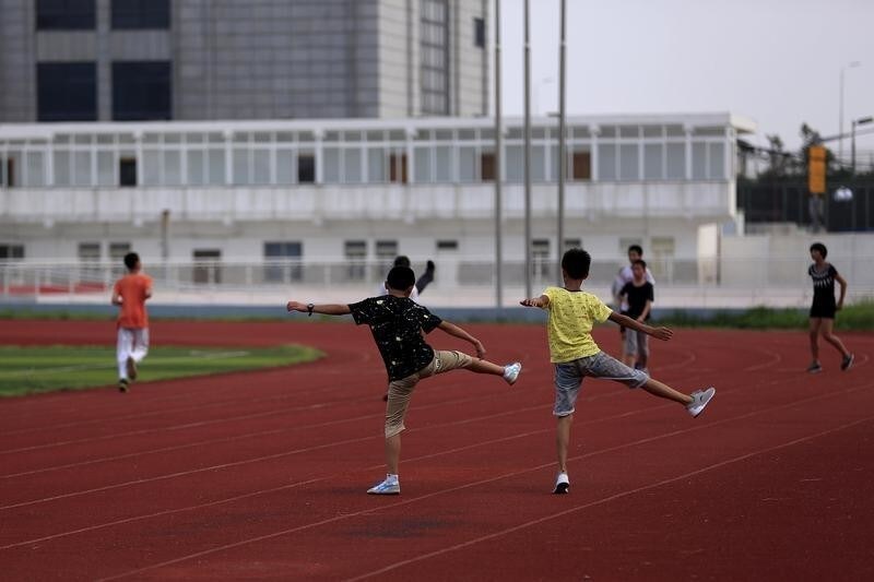 Youths attend a daily track-and-field class, part of a training course at the Jinshan Youth Spare-time Sports School, in Shanghai, August 25, 2015. About 30 youths, between 10 and 14 years old, are enrolled in the course where the top participants will be selected to be groomed to become professional athletes. REUTERS/Aly Song - GF10000181949