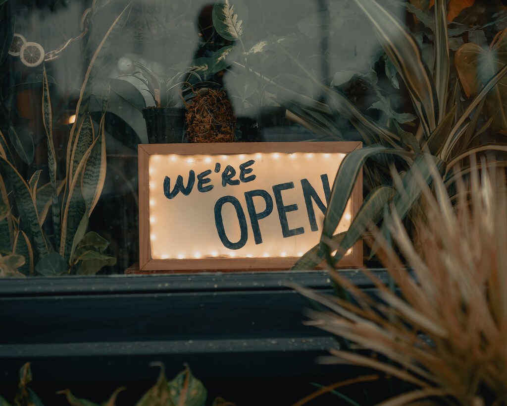 A lit-up sign saying 'we're open'.